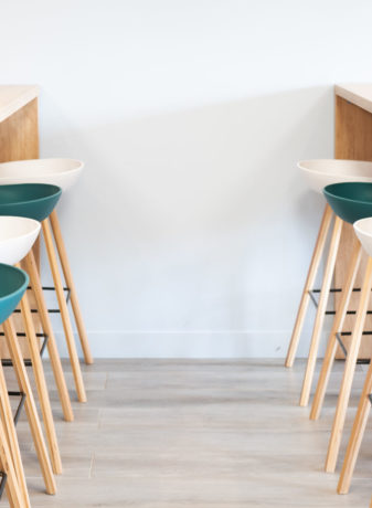 Réfectoire chez Carbogen Amcis, aménagé avec du mobilier moderne comprenant des tables haute SWARM et des tabourets élégantes aux couleurs de leur marque, offrant un espace convivial pour les pauses café et les repas informels.